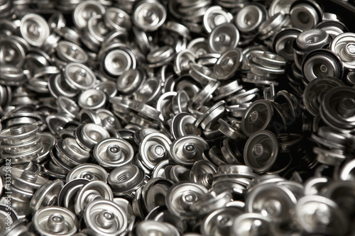 Photo: Pile of metal can tops Pile of metal can tops