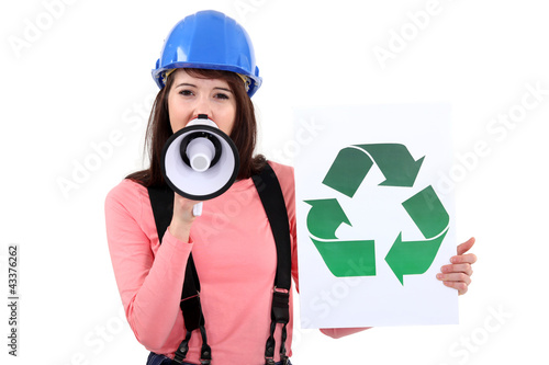 Photo: female apprentice shouting in loudspeaker shows recycling logo female apprentice shouting in loudspeaker shows recycling logo