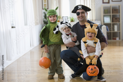 Photo: Mixed race father and sons in Halloween costumes Mixed race father and sons in Halloween costumes