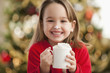 Caucasian girl drinking hot chocolate at Christmastime