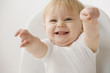 Grinning Caucasian baby boy pointing