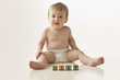 Mixed race baby boy playing with alphabet blocks
