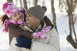 Daughter hugging father in snow