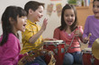 Students playing musical instruments in classroom
