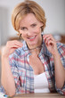 Blonde woman taking off her glasses