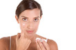 woman putting on contact lens