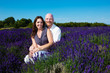 Happy middled aged couple in a field of purple lavender