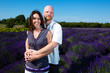 Happy middled aged couple in a field of purple lavender