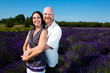 Happy middled aged couple in a field of purple lavender