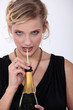 Woman drinking champagne through a straw