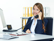 Foto: Secretary at work calling a customer for service Secretary at work calling a customer for service