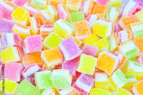 Photo: A pile of candies on a white background. Close-up of colorful ca A pile of candies on a white background. Close-up of colorful ca