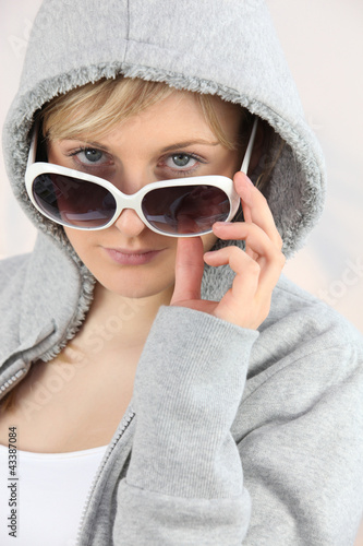Photo: Girl with sunglasses and hoodie Girl with sunglasses and hoodie