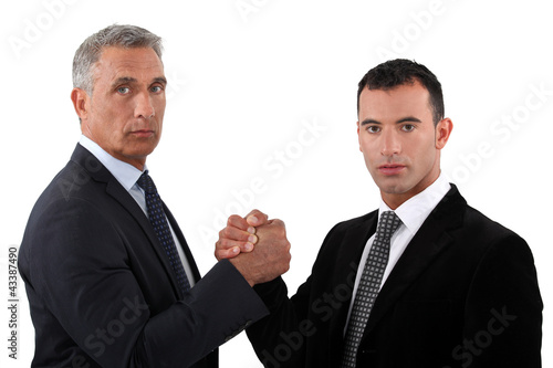 Photo: Businessmen forming a pact Businessmen forming a pact