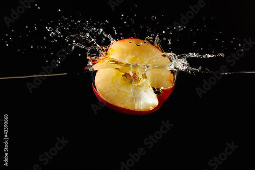 Photo: Halved apple falling into the water with a splash Halved apple falling into the water with a splash
