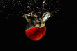 Halved fresh apple falling into the water with a splash