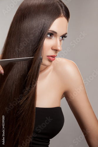 Photo: Beautiful Woman combs her Healthy Long Hair. High quality image. Beautiful Woman combs her Healthy Long Hair. High quality image.