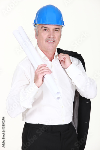 Photo: Engineer carrying rolled-up blueprints Engineer carrying rolled-up blueprints
