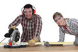Couple using circular saw