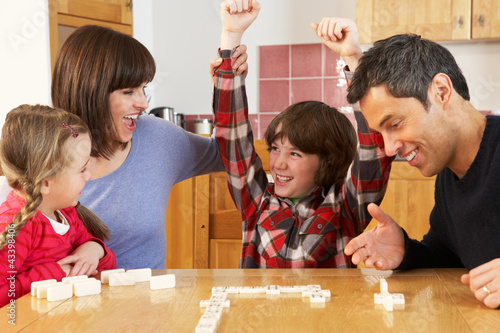 Photo: Family Playing Dominoes In Kitchen Family Playing Dominoes In Kitchen