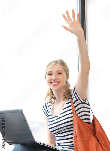 Foto: happy teenage girl waving a greeting happy teenage girl waving a greeting