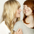 blond and red haired girls are laughing