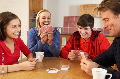 Photo: Family Playing Cards In Kitchen Family Playing Cards In Kitchen