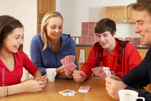 Photo: Family Playing Cards In Kitchen Family Playing Cards In Kitchen