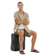 Photo: Happy tourist sitting on wheels bag Happy tourist sitting on wheels bag