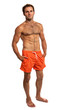 Photo: Muscular young man in swimwear standing on white Muscular young man in swimwear standing on white
