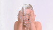 Happy woman in slow motion splashing her face