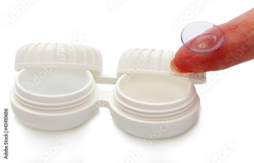Photo: contact lens on finger and case isolated on white contact lens on finger and case isolated on white