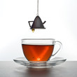 Tea is poured into a transparent cup