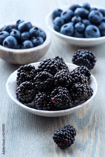 Photo: Blackberries and blueberries in small bowls Blackberries and blueberries in small bowls
