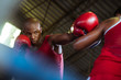 Foto: Two male athletes fight in boxing ring Two male athletes fight in boxing ring
