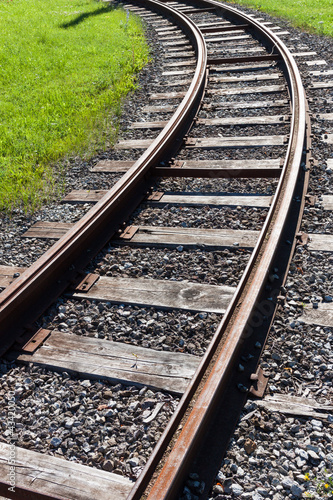 Photo: Railway rail road track disappearing around a curve Railway rail road track disappearing around a curve