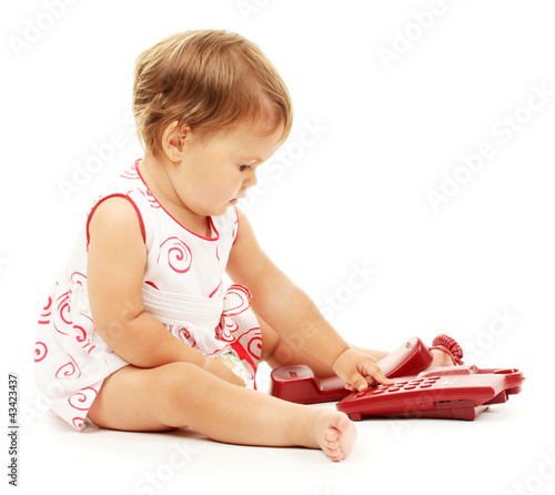 Photo: Cute baby with telephone isolated on white Cute baby with telephone isolated on white