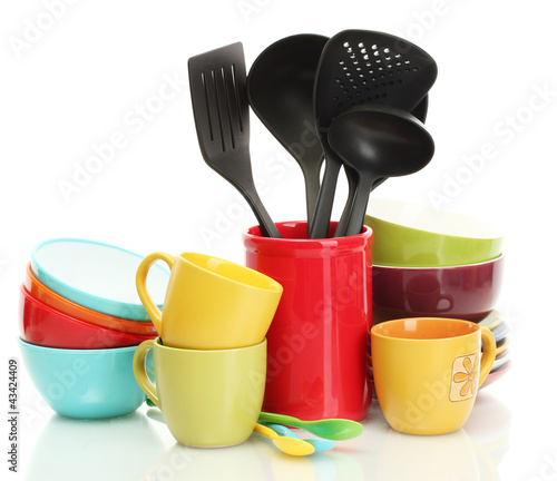 Photo: bright empty bowls, cups and kitchen utensils isolated on white bright empty bowls, cups and kitchen utensils isolated on white