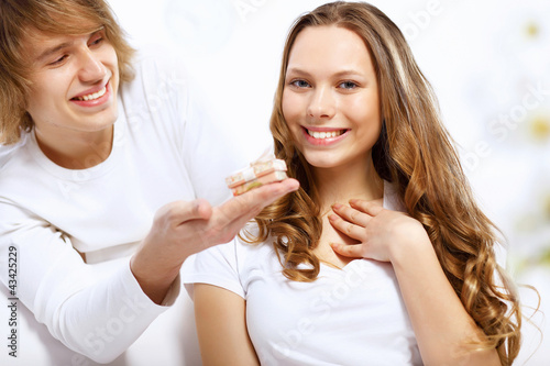 Photo: Young couple at home with present Young couple at home with present