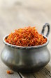 saffron treads in pile,  wooden board