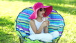 Happy child sitting in a chair outdoors