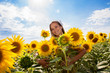 woman on blooming sunflower field
