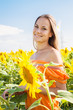 Happy girl in sunflower field