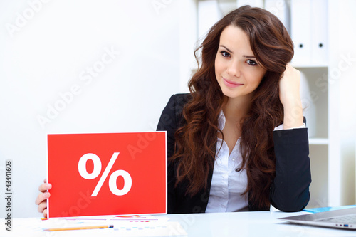 Photo: Young business woman with sale sign Young business woman with sale sign