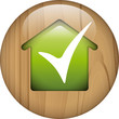 wooden button with green house and ok