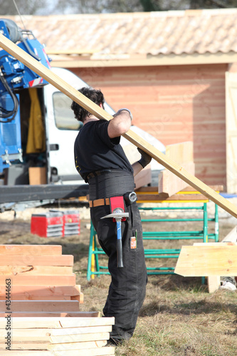 Photo: carpenter holding planks carpenter holding planks