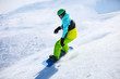 Photo: Snowboarder sliding down a slope on a sunny day Snowboarder sliding down a slope on a sunny day