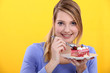 Woman eating a strawberry cake