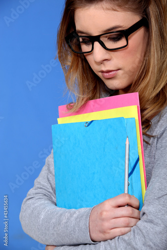 Photo: Young student carrying files Young student carrying files