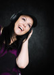 Photo: smiling woman with headphones listening music smiling woman with headphones listening music